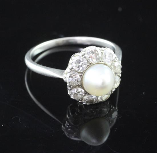 A 1920s platinum, cultured pearl and diamond cluster ring, size M.